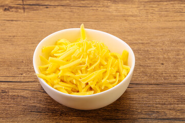 Shredded yellow cheese in the bowl