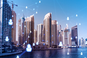 Skyscrapers of Dubai business downtown. International hub of trading and financial services. Social network icons hologram, concept of human resources. Double exposure. Dubai Canal waterfront.