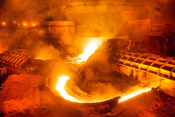blast furnace iron tapping. Hot steel is poured into another pan