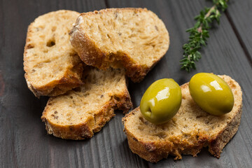 Green olives and slices of bread