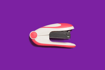 stapler on a purple background