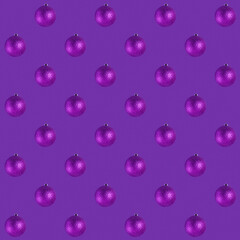 Seamless pattern with purple baubles on purple. Christmas monochromatic background