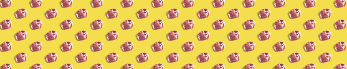 background with raw pork meat slices on yellow background, raw food background, not pattern, banner wide shoot