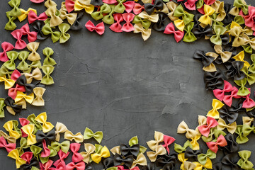 Naklejka na ściany i meble Frame of pasta - flay lay of Italian colorful farfalle, top view