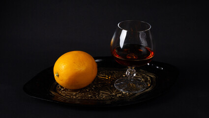 Glass of cognac and lemon