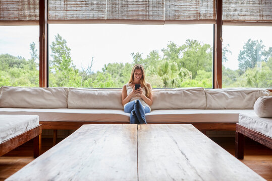 Smiling Mid Adult Woman Using Smartphone