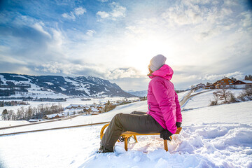 Germany, Bavaria, Allgäu, Woman enjoying a winter day sledding