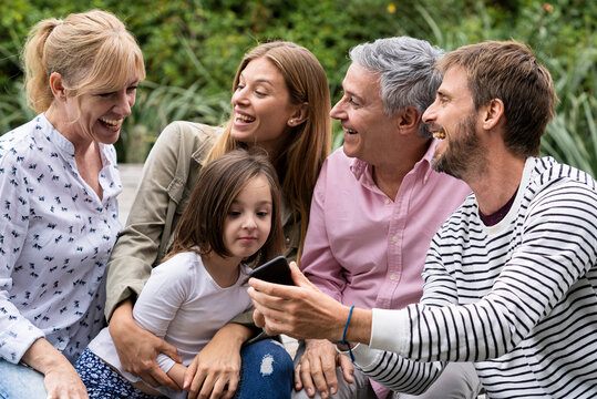 Family looking at smartphone