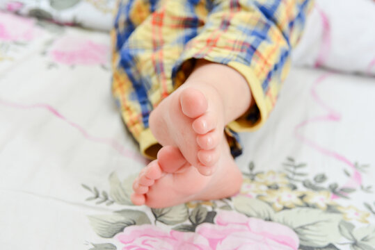 Baby feet close-up, baby lies on his stomach, photo of baby feet.
