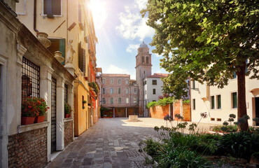 Venice Italy. Picturesque yard old town with tower and vintage houses. Sunny day
