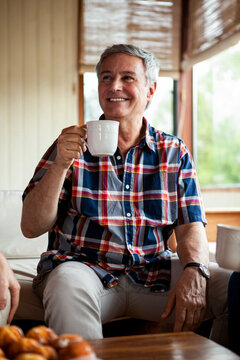 Smiling senior man having coffee