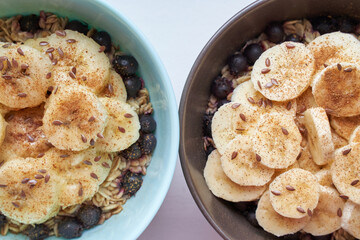 Healthy breakfast. Top view. Oatmeal with banana and flax seeds at bowl. Berry in plate. Organic meal recipe. Vegan cook. Minimalism granola. Hot porrigde with fruit. Closeup