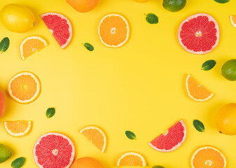 Mixed citrus fruit with mint leafs in a yellow background. high resolution background