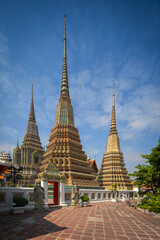 Fototapeta premium Beautiful stupas decorated with colorful mosaic big pagoda and Thai art architecture of Wat Pho temple in Bangkok, Thailand.