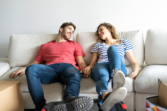Young couple relaxing on sofa in their new house
