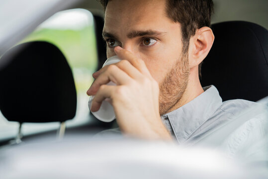 Close-up of young man drinking coffee