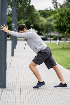 Young man exercising in public park