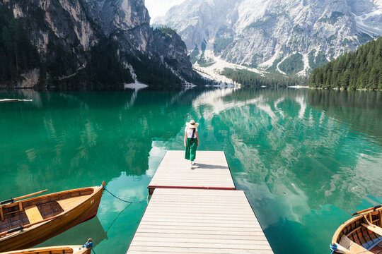 a girl walks along the pier, italy lake bries