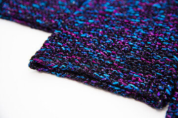Knitted blue, black and purple colored texture background with white copy space