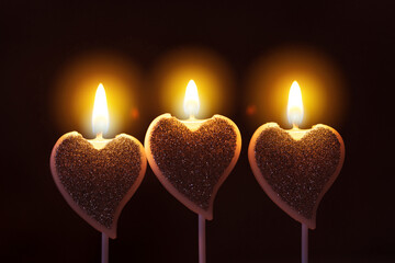 Valentine day greeting card with three heart-shaped burning glowing candles with warm flame