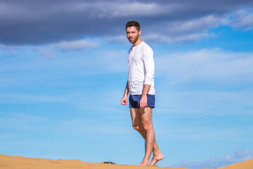 Young man walking in the dunes in Gran Canaria