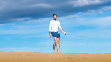 Young man walking on the dunes in Gran Canaria in December 2020 during Covid