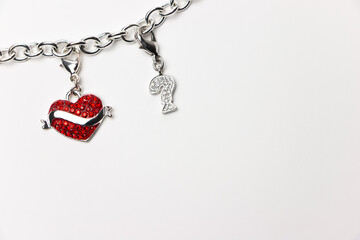 Red heart hanging on a chain along with a question mark. Love
