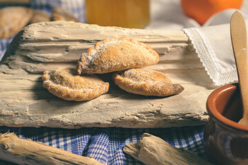 Tortosa cakes. Typical Tortosa dessert from Terres de l'Ebre. Angel hair cakes on a rustic and elegant wood, with honey and orange in the background and on a blue decorative cloth