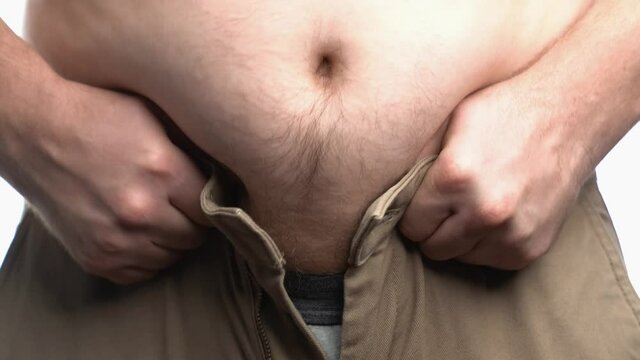 Fat men body trying to put on he shorts