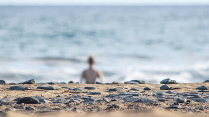 Blurry woman taking a swim in Atlantic Ocean during Covid in Gran Canaria