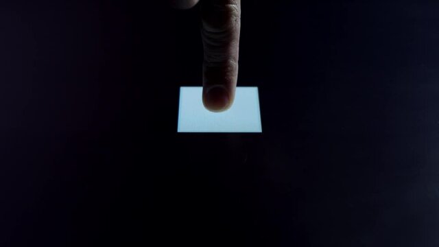 Human finger is pressing a digital button on a glowing touchscreen. Futuristic microprocessor is starting the operation of the computer program. Machine learning and artificial intelligence.
