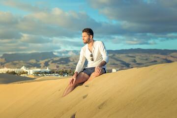 Fototapeta na wymiar Man in the dunes in Maspalomas in Gran Canaria during sunset