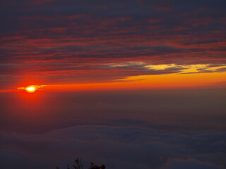 sunset with sea of clouds over the high-altitude mountains