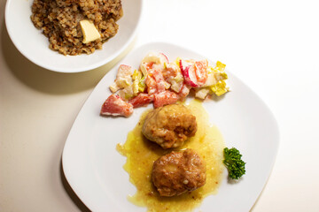 pork cutlets with buckwheat porridge garnish on a white background