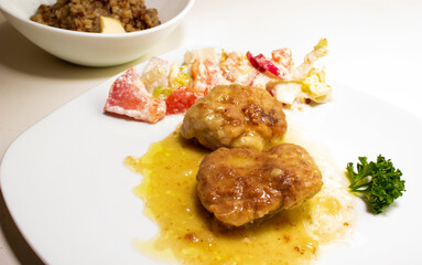 pork cutlets with buckwheat porridge garnish on a white background