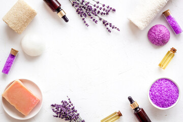 Fototapeta na wymiar Frame flat lay of lavender cosmetics - bath salt and essential oil, top view