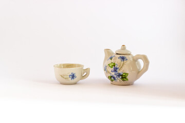 Ceramic mini tea set isolated on white background. Miniature blue and white ceramic tea set.