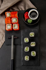 Slide motion of sushi food served on black stone