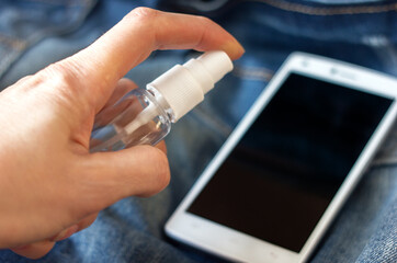 Hand of woman is spraying alcohol,disinfectant spray on mobile phone,prevent infection of Covid-19 virus,contamination of germs or bacteria,wipe or cleaning phone to eliminate
outbreak of Coronavirus