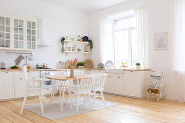 cute cozy light interior design of the apartment with a free layout of the kitchen and bedroom areas. a lot of windows, a wooden floor and a hanging swing.