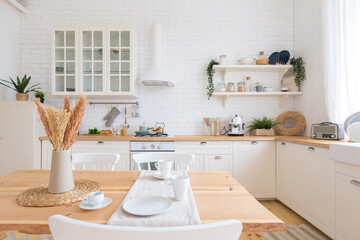 cute cozy light interior design of the apartment with a free layout of the kitchen and bedroom areas. a lot of windows, a wooden floor and a hanging swing.