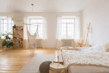 cute cozy light interior design of the apartment with a free layout of the kitchen and bedroom...