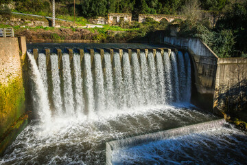 River waterfall in the city of Pernes, Ribatejo, Portugal. Waterfalls of the river Alviela