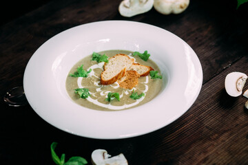 Mushroom cream soup on a white plate