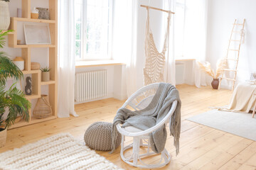 cute cozy light interior design of the apartment with a free layout of the kitchen and bedroom areas. a lot of windows, a wooden floor and a hanging swing.
