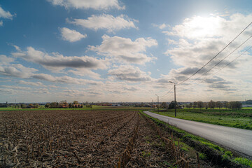 Landscape in city Izegem, a road with different weather condictions, blue hour, blue sky, clouded, road that leads in the landscape