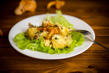 fried omelet with forest mushrooms chanterelles, on table