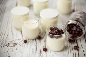 Homemade sweet yogurt with frozen berries in a glass