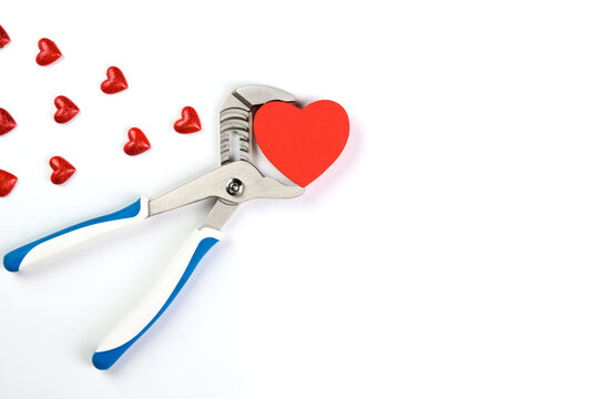 . Wrench with hearts isolated on background. The concept of your favorite profession and Valentine's Day.