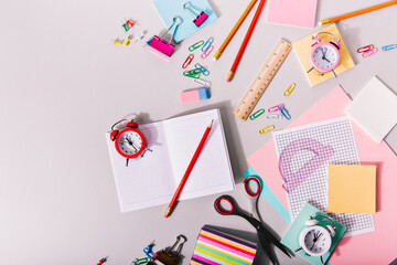 Shot of pencils, notebooks and rulers of different colors on white background
